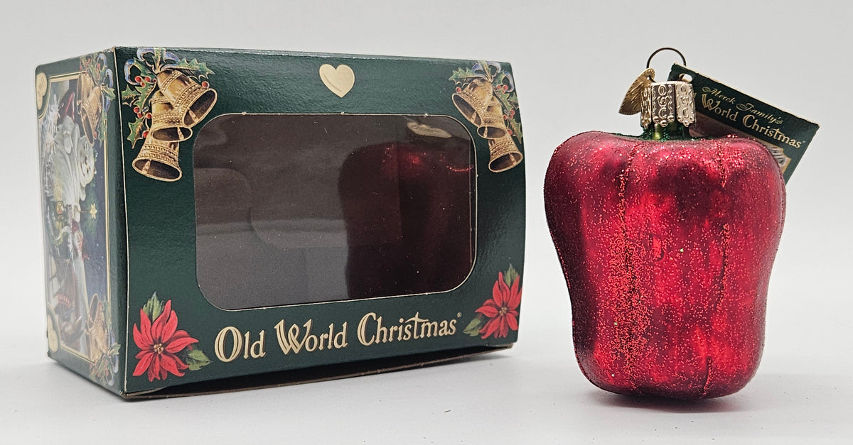 Old World Christmas Bell Pepper – Red ornament #28087 – ornament alongside photographed packaging