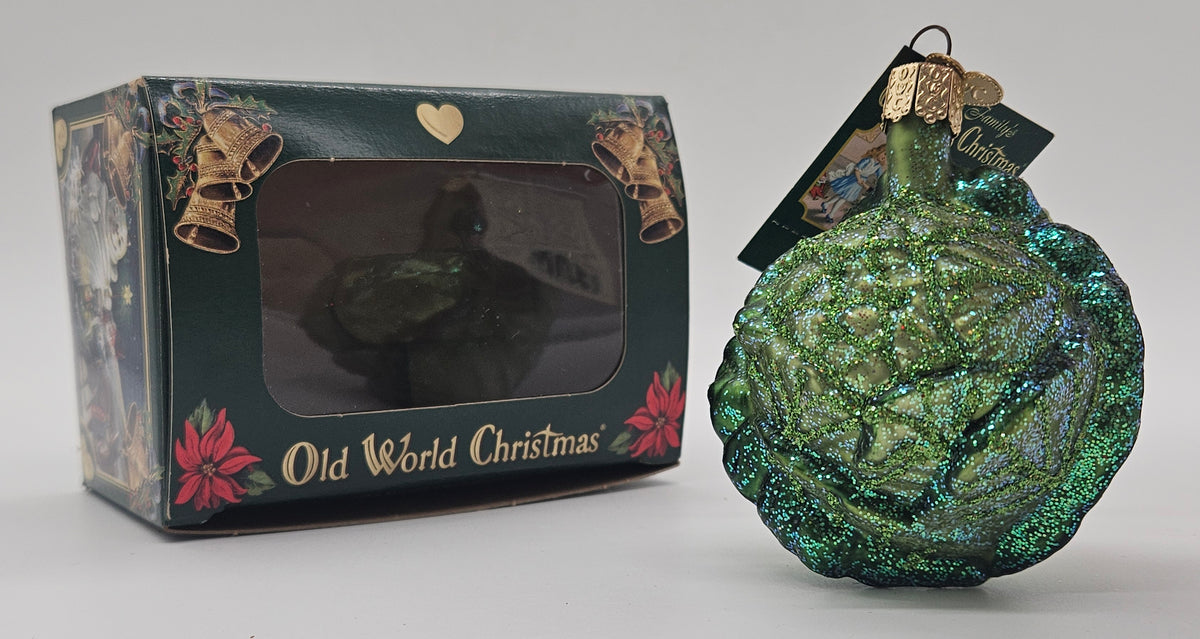 Old World Christmas Iceberg Lettuce ornament #28092 – ornament alongside photographed packaging