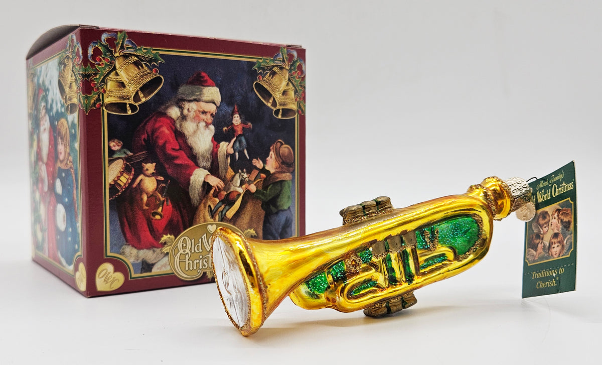 Old World Christmas Trumpet – Green ornament #38019 – ornament alongside photographed packaging
