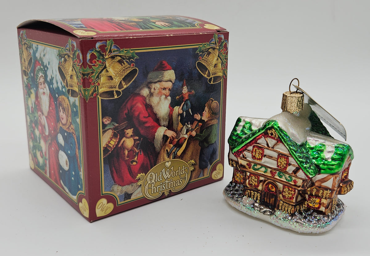 Old World Christmas Alpine House ornament #20042 – ornament alongside photographed packaging