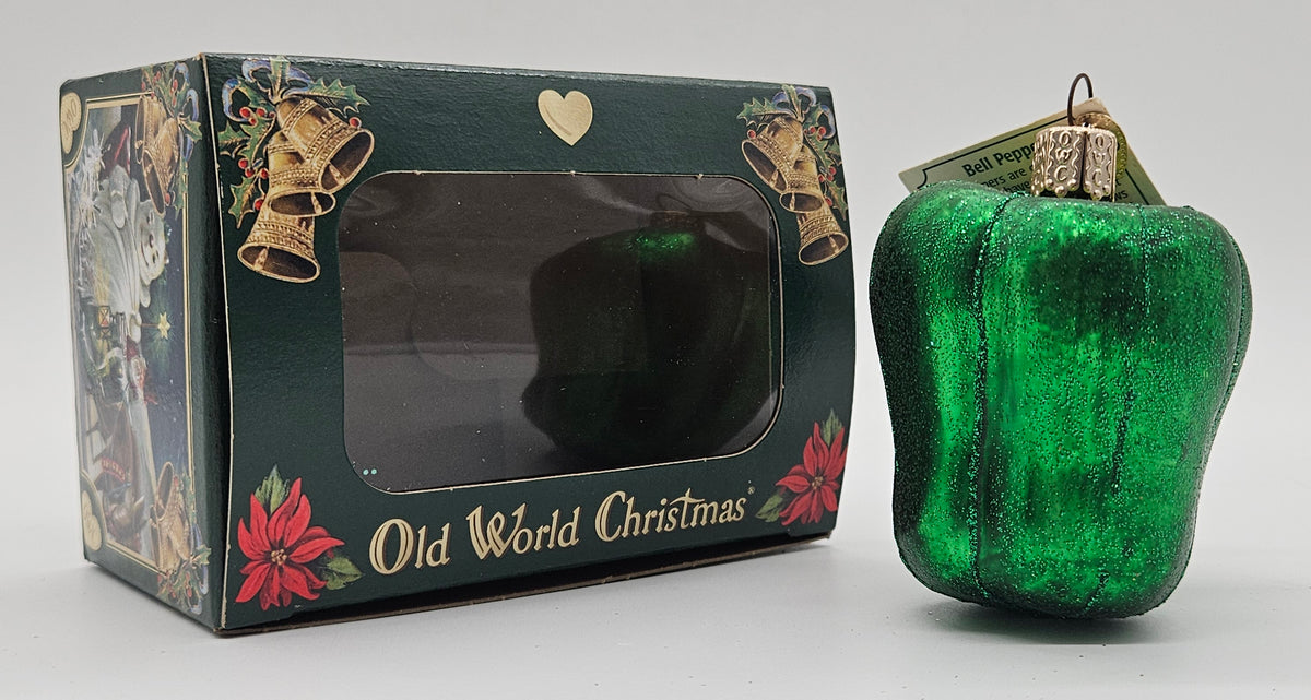 Old World Christmas Bell Pepper – Green ornament #28087 – ornament alongside photographed packaging