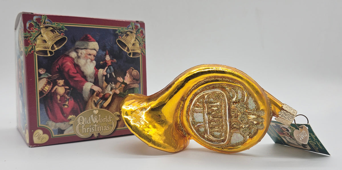 Old World Christmas French Horn ornament #38015 – ornament alongside photographed packaging