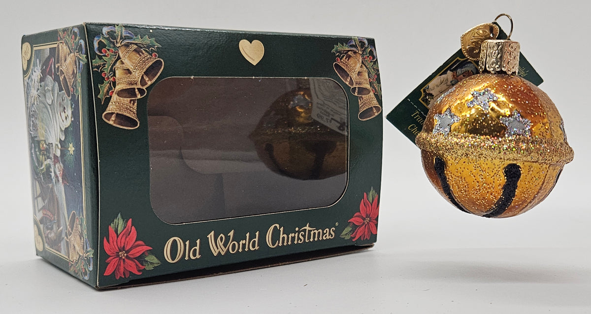 Old World Christmas Jingle Bell – Gold ornament #38022 – ornament alongside photographed packaging
