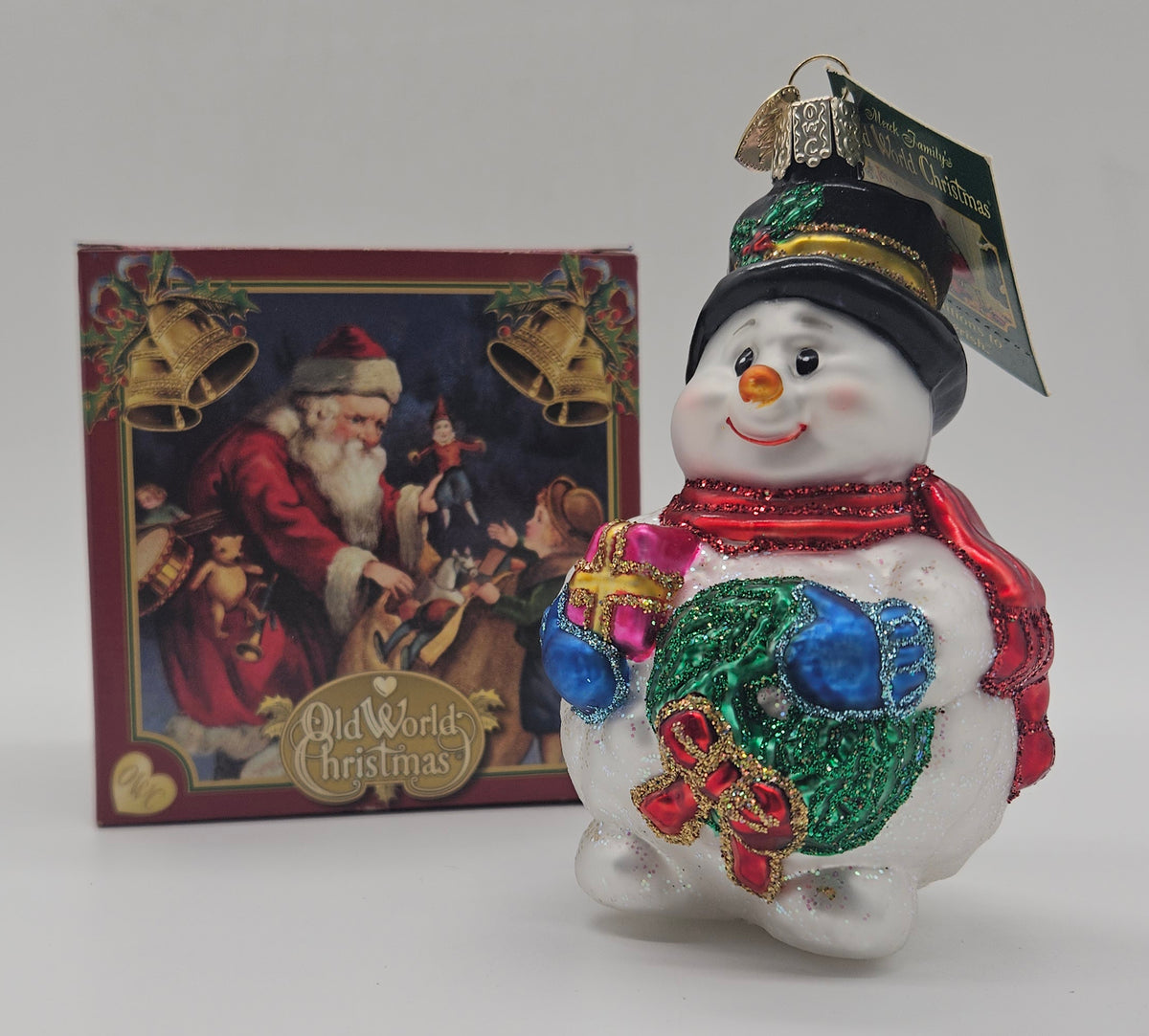 Old World Christmas Lumpy Snowman ornament #24093 – ornament alongside photographed packaging