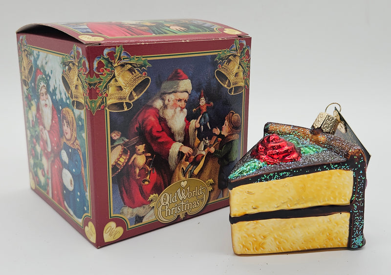 Old World Christmas Piece of Cake – Chocolate ornament #32038 – ornament alongside photographed packaging