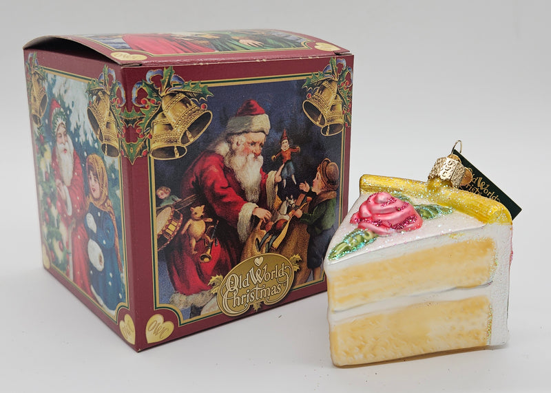 Old World Christmas Piece of Cake – Vanilla ornament #32038 – ornament alongside photographed packaging