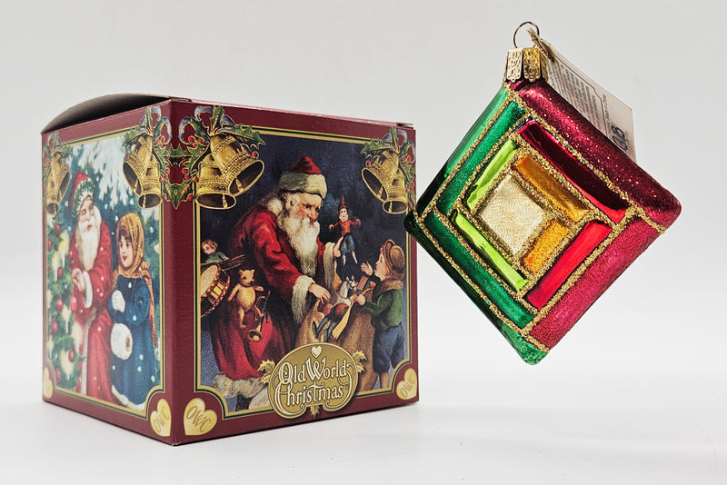 Old World Christmas Quilt Square ornament #32149 – ornament alongside photographed packaging