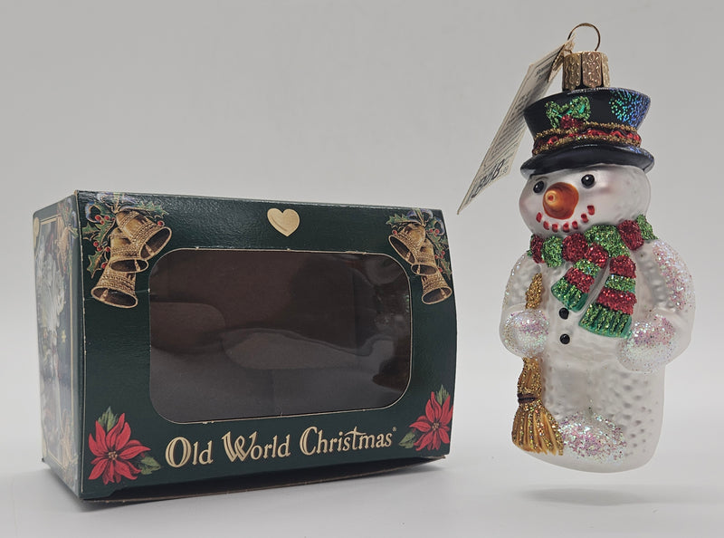 Old World Christmas Snowman with Broom ornament #24013 – ornament alongside photographed packaging